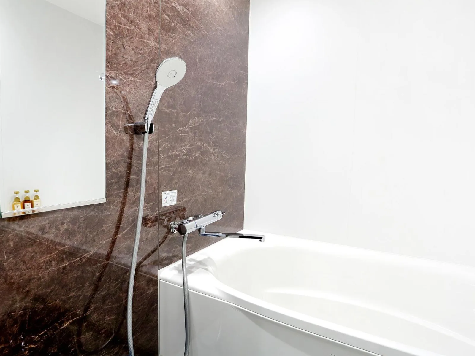 Bright bathroom at RE Hotel Umeda-2 in Osaka with vessel sink and toilet.