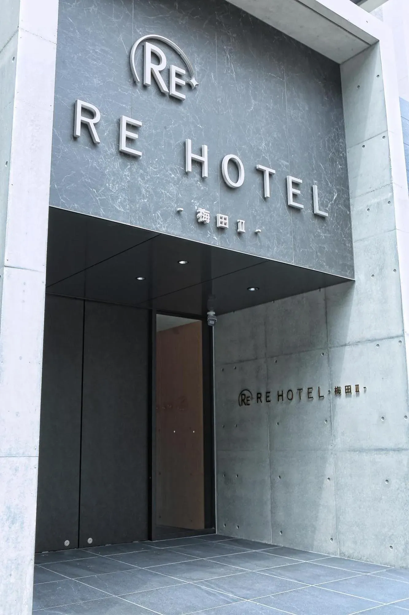 Second exterior view of RE Hotel Umeda-2 in Osaka showing the entrance and signage.