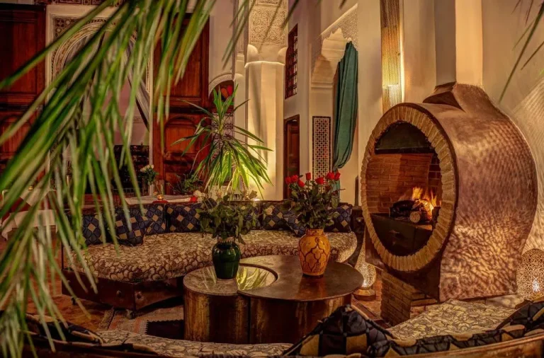 Cozy lounge area in Riad Almaz, Fes with seating and a fireplace