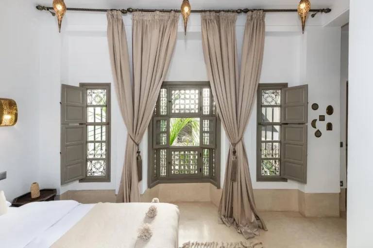 Riad Louhou – Marrakech, Morocco hotel – a bedroom with a bed and large windows at Riad Louhou in Marrakech