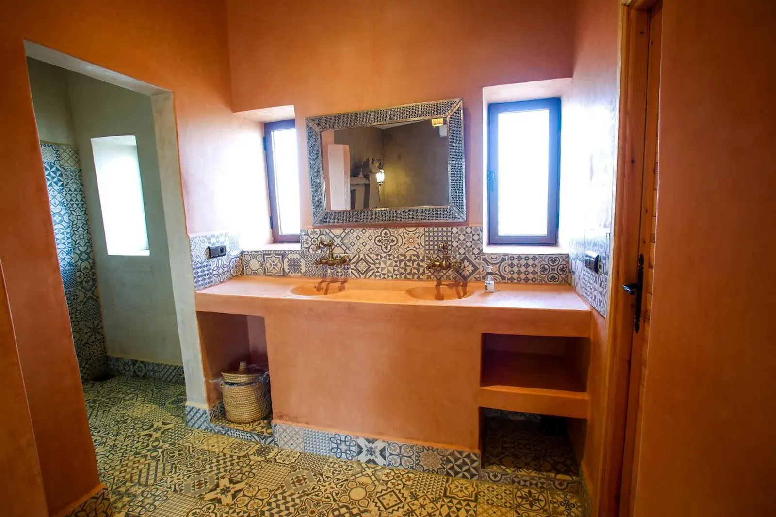 Chic bathroom with artistic tiles at Riad Suerteloca Merzouga