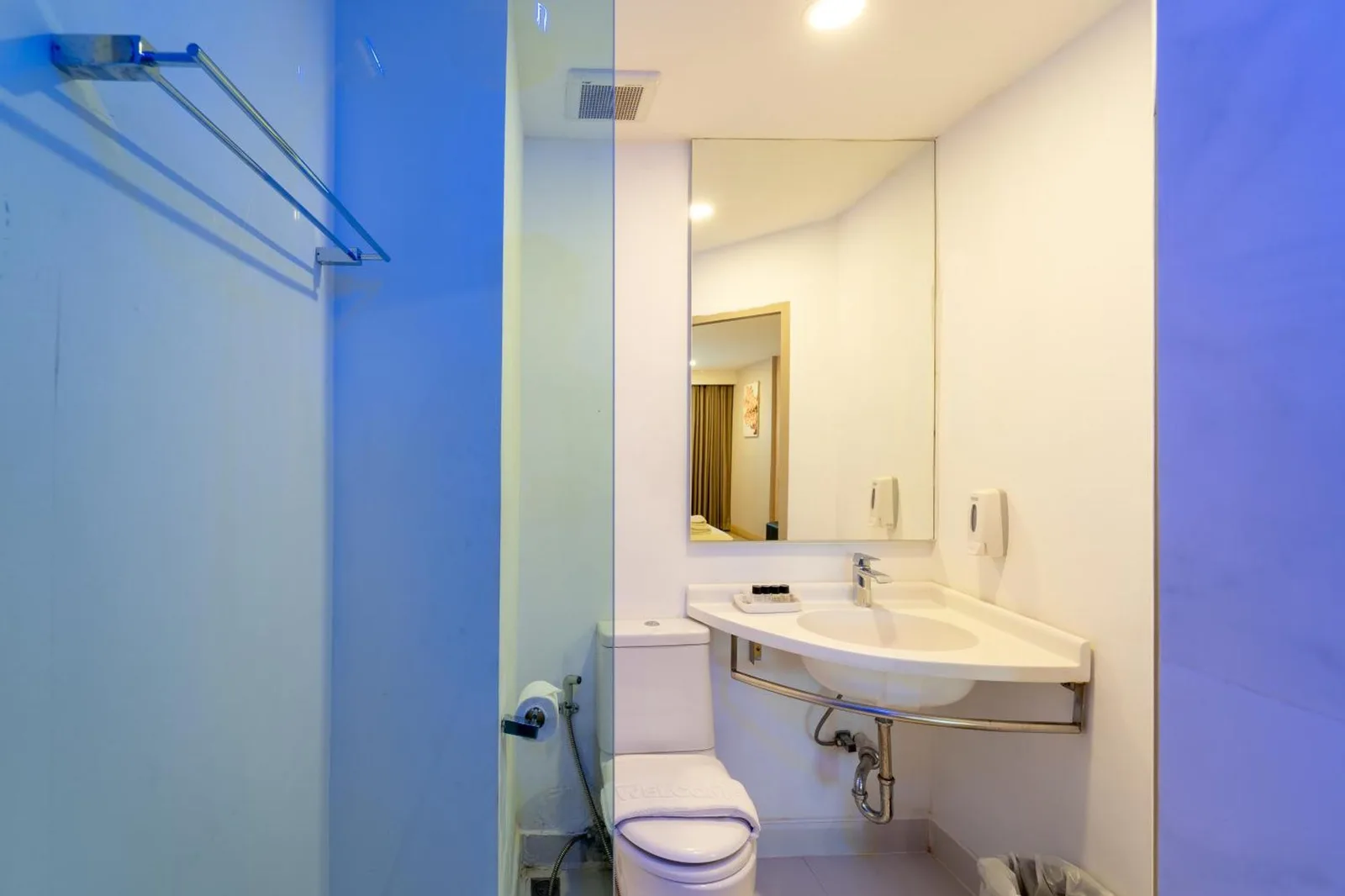 Rodina Beach Hotel Pattaya bathroom shower area with sink, mirror, and glass partition
