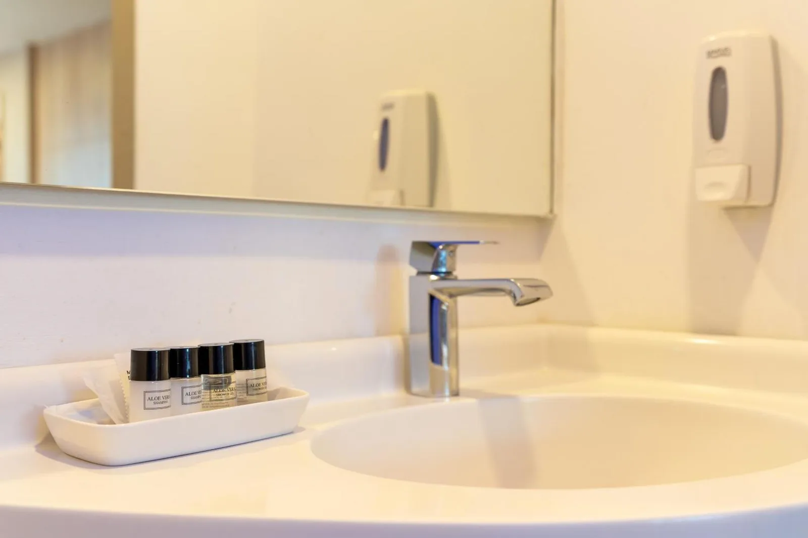 Rodina Beach Hotel Pattaya bathroom sink with toiletries and modern countertop basin