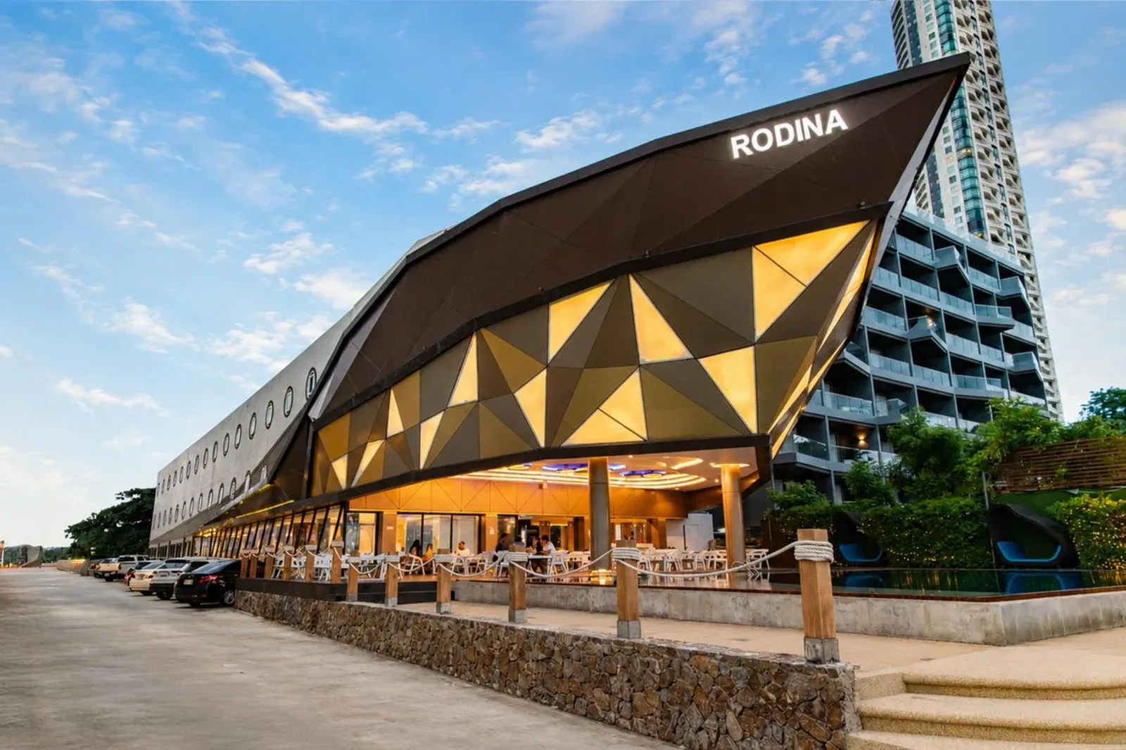 Rodina Beach Hotel in Pattaya exterior view with modern geometric facade and waterfront dining area