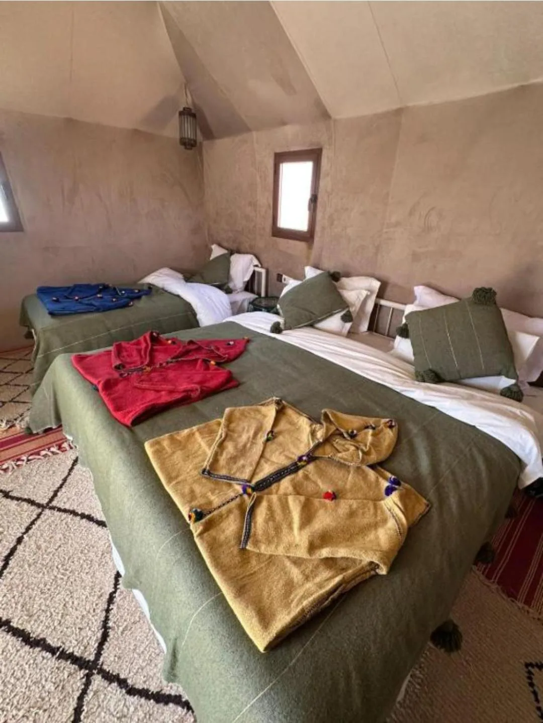 Rosara Luxury Camp in Merzouga family tent with multiple beds and colorful blankets