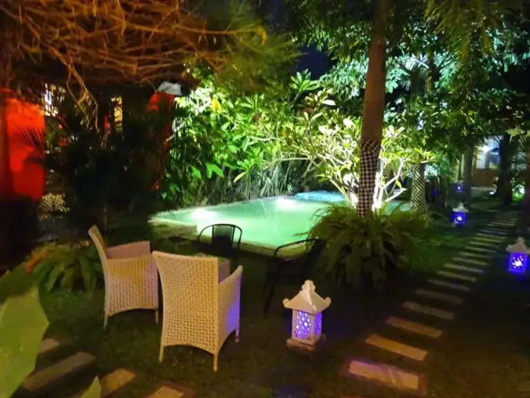 Garden area with pool lighting at Rosseno Villa