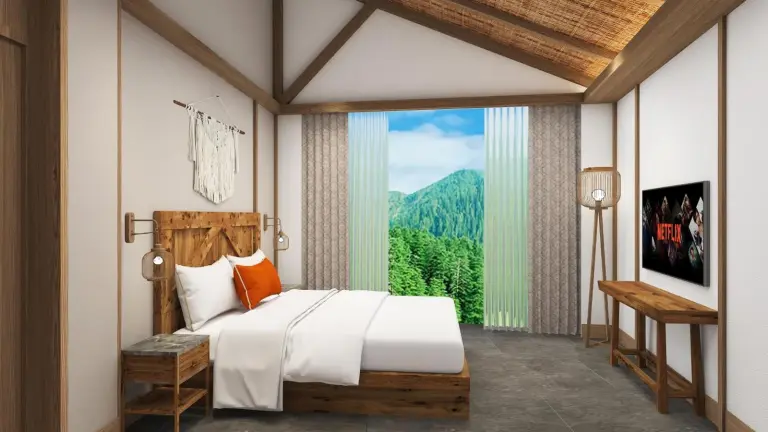 Dormitorio con ventana y vistas a la montaña en Royal Tulip Chitwan Nepal en Sauraha