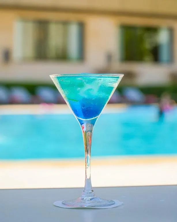 Cocktail by the pool at Royal Tulip City Center