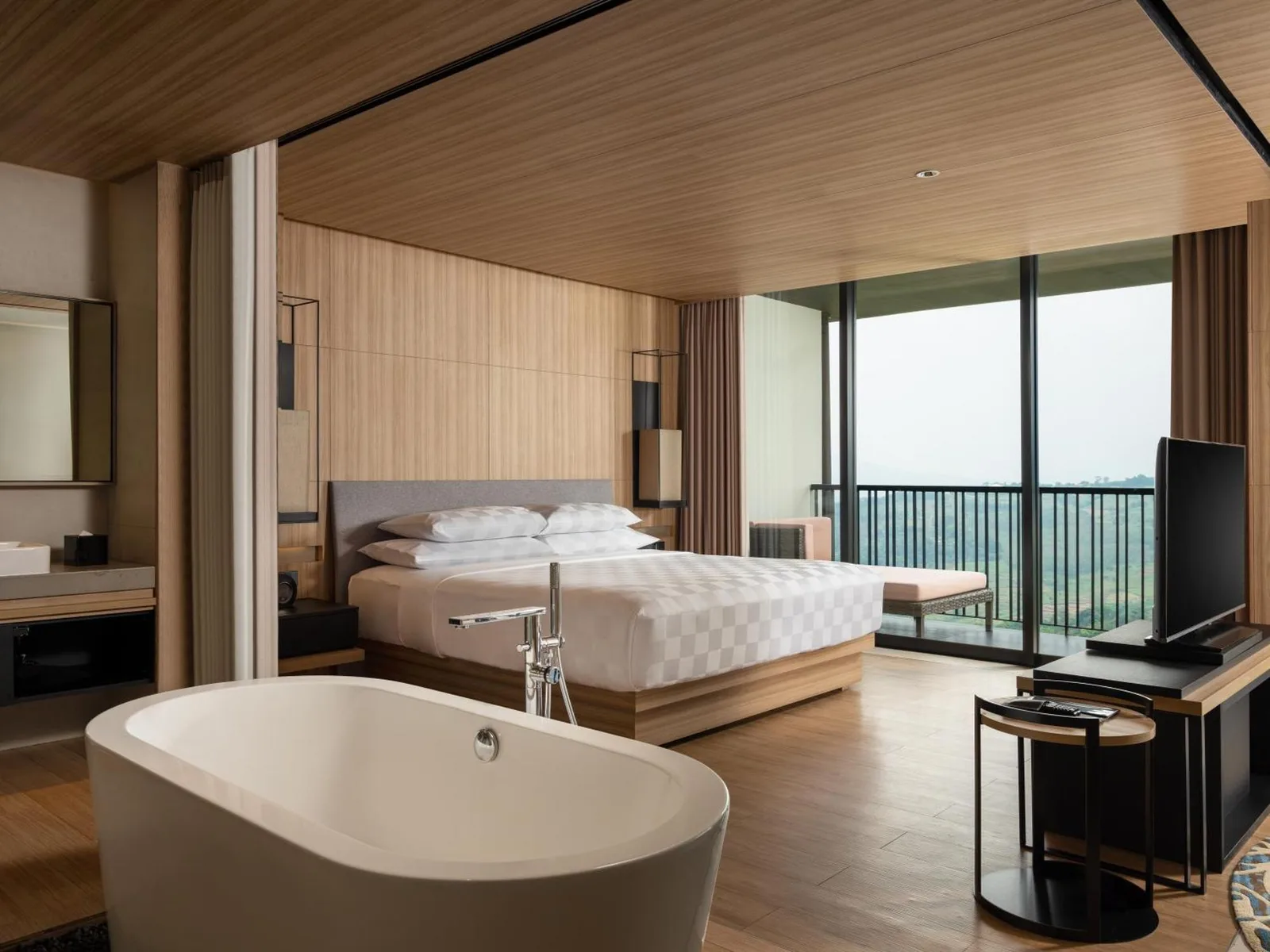Luxury suite with bathtub at Royal Tulip Gunung Geulis Resort and Golf in Bogor.
