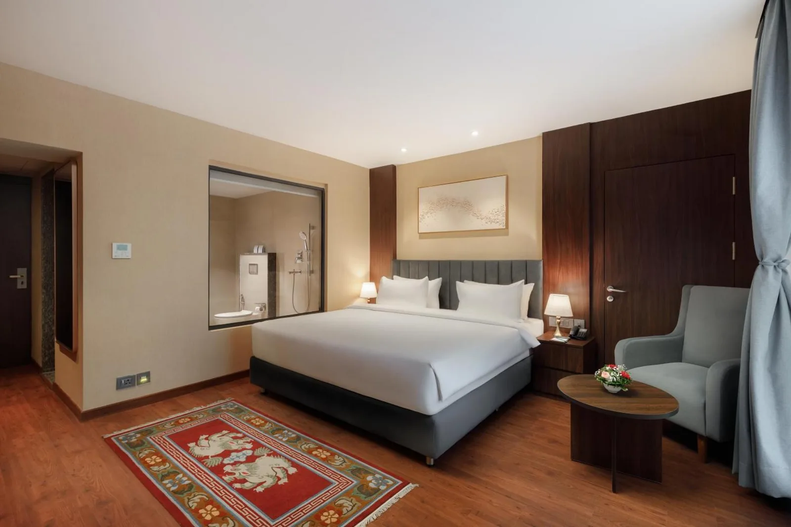Modern guest room at Royal Tulip Kathmandu with large TV, desk, and window