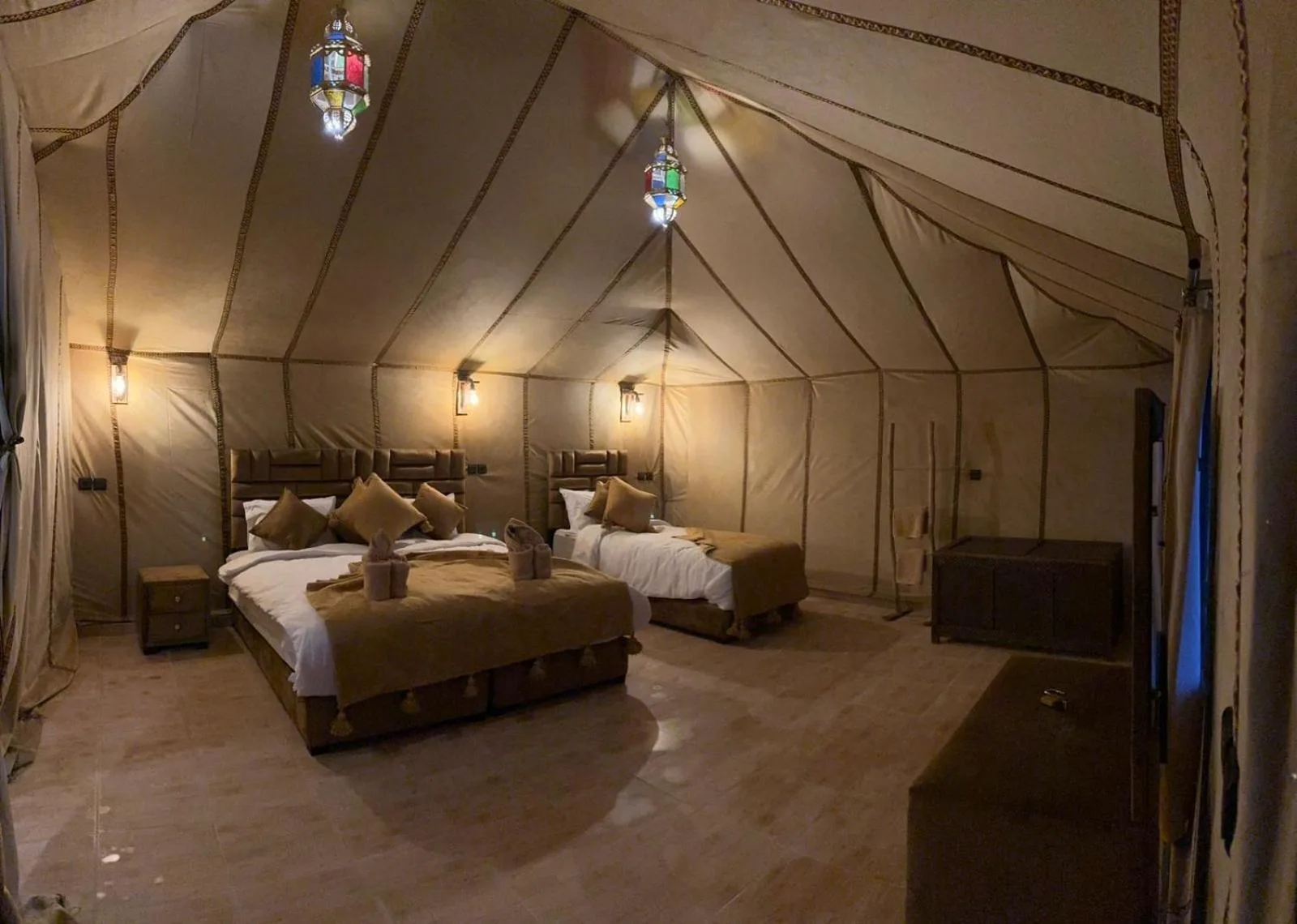 Large family tent room at Safari Desert Camp in Merzouga with multiple beds and traditional decor