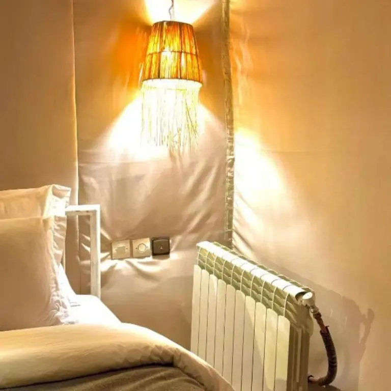 Sahara Soul Luxury Camp in Merzouga tent bedroom detail with bedside lighting and heating for added comfort.