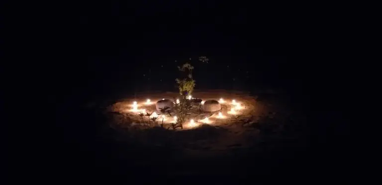Nighttime fire circle at Sahara Tours luxury camp in Merzouga