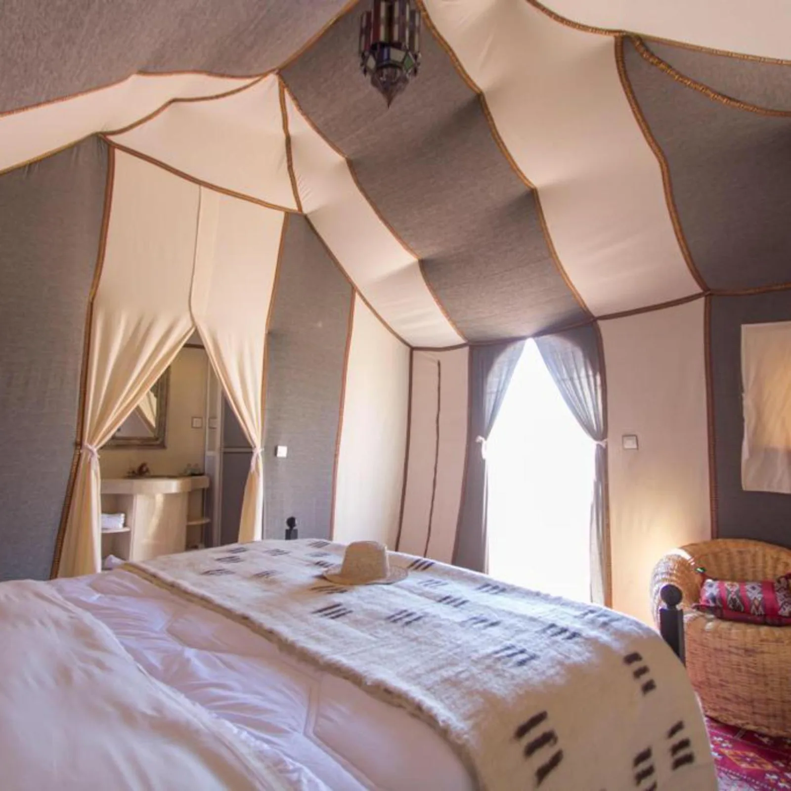 Elegant tent bedroom inside Sahara Tours luxury camp in Merzouga