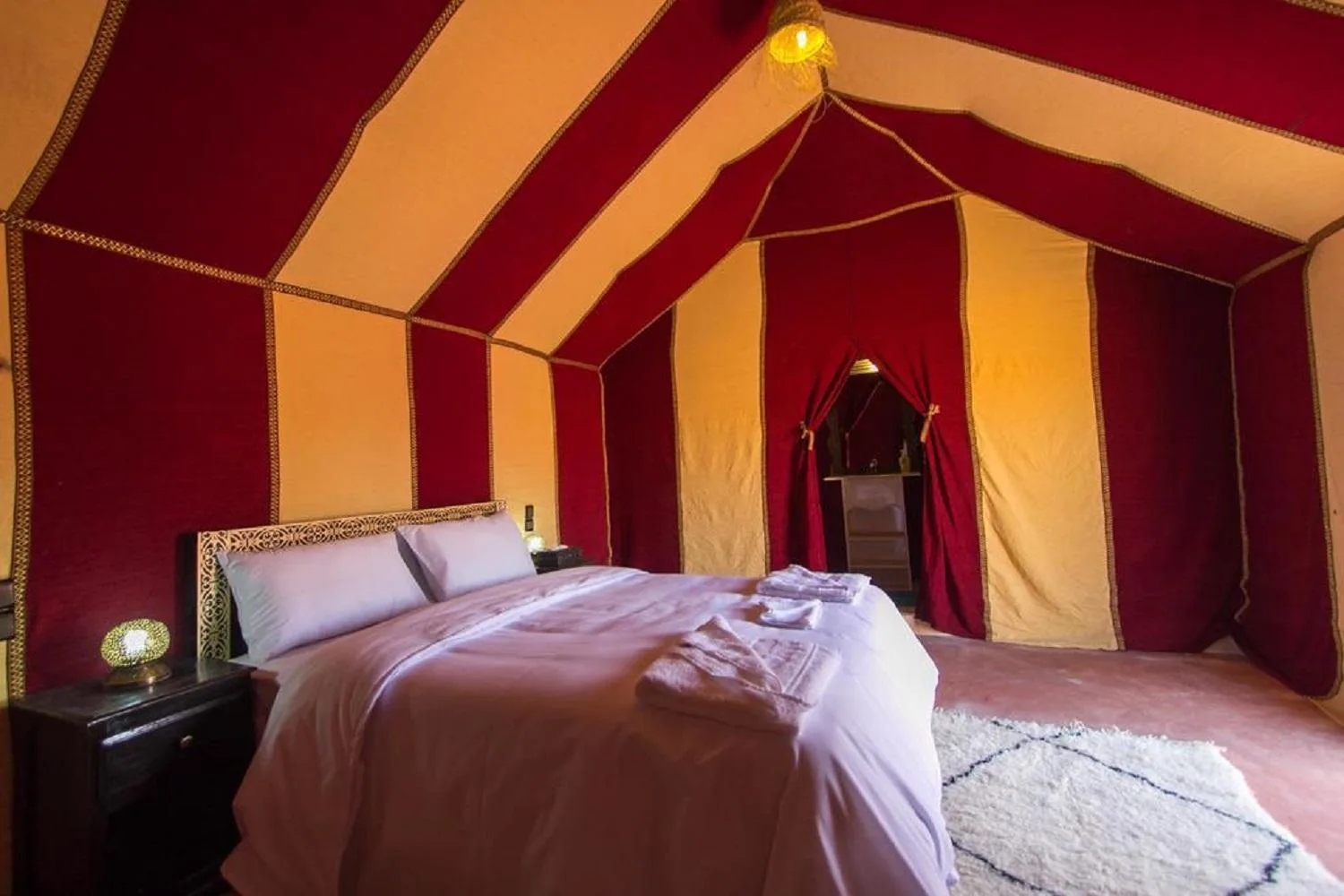 Red themed bedroom in Sahara Traditional Luxury Camp
