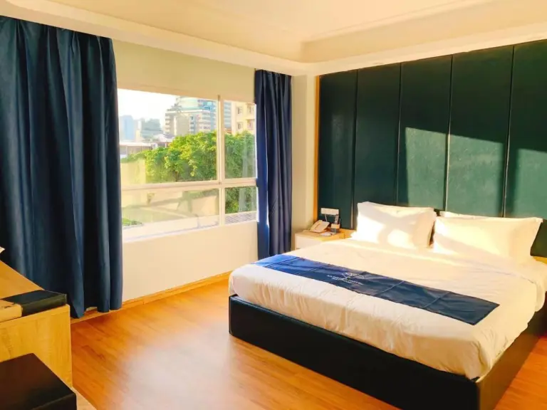 Sapphire Hotel Silom Bangkok – Bangkok, Thailand hotel – a bedroom with a large bed and a large window at Sapphire Hotel Silom Bangkok in Bangkok