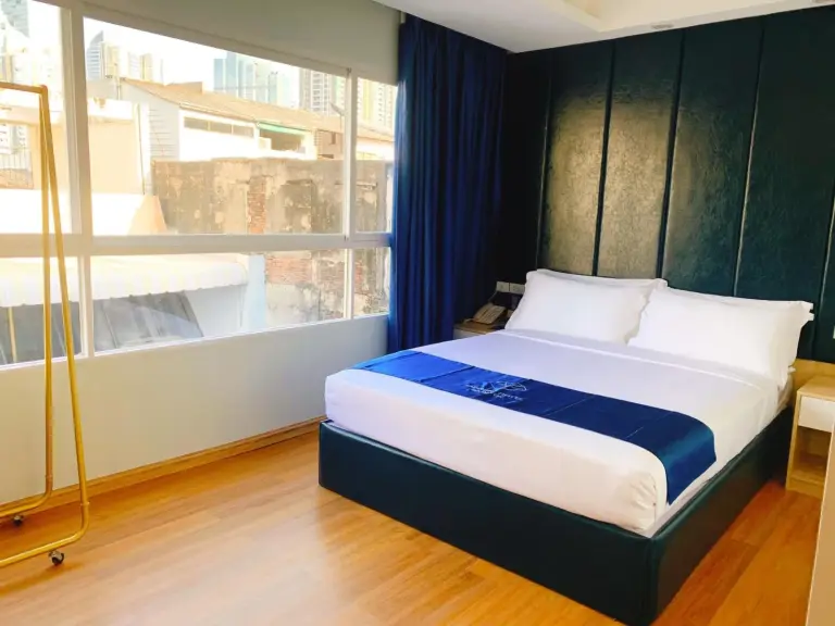 Bright guest room with large window and double bed at Sapphire Hotel Silom Bangkok Bangkok