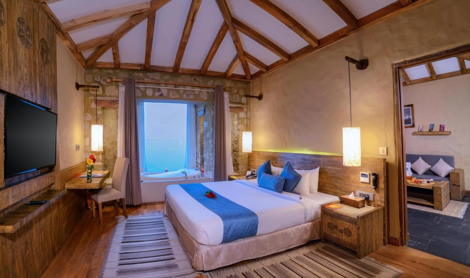 Sarangkot Mountain Lodge – Pokhara, Nepal hotel – a living room with a couch and a table at Sarangkot Mountain Lodge in Pokhara