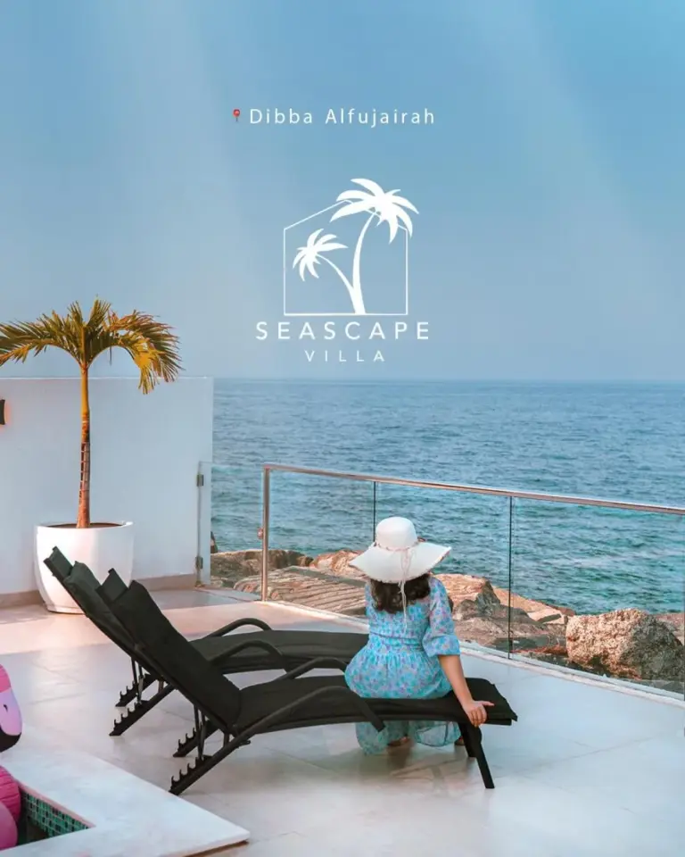Person relaxing by Seascape Villa pool