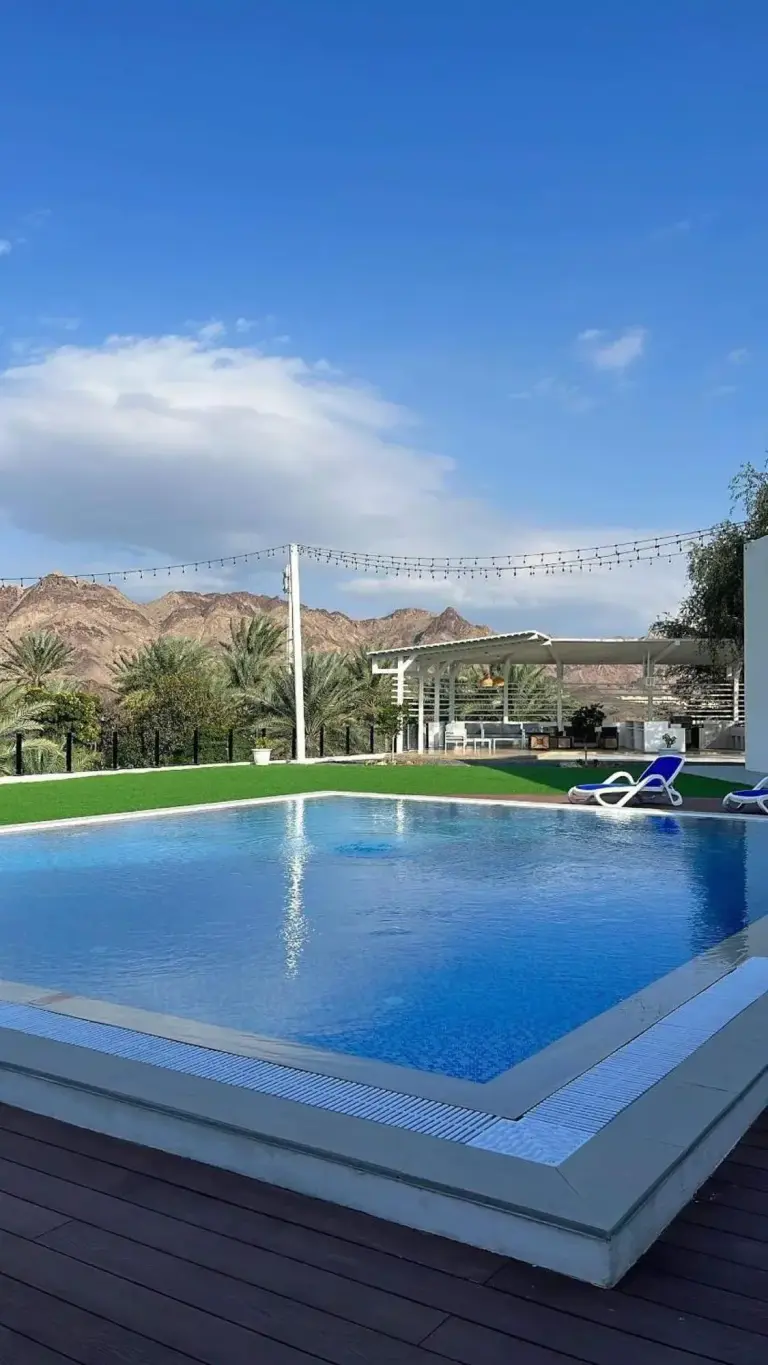 Sheema Lodge pool with mountain backdrop
