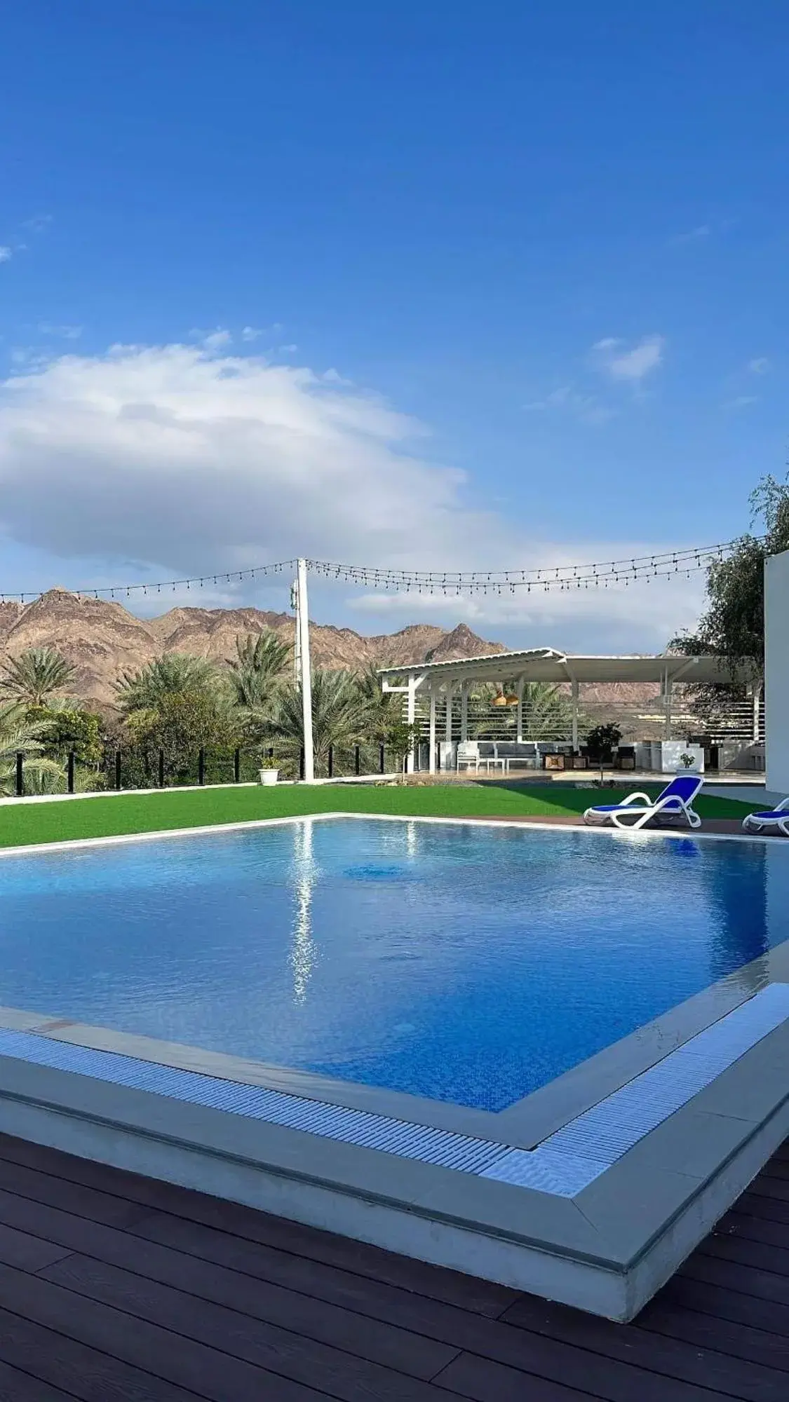 Sheema Lodge pool with mountain backdrop