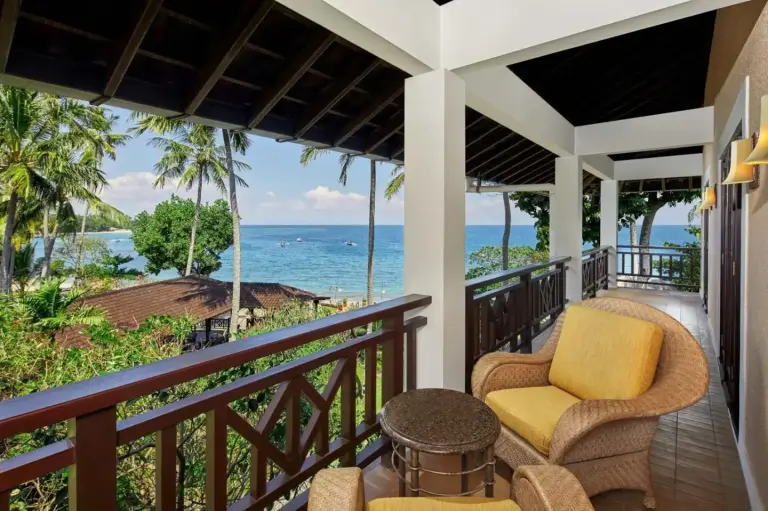 Sheraton Senggigi Beach Resort – Mataram, Indonesia hotel – a balcony with two chairs and a table and the ocean at Sheraton Senggigi Beach Resort in Senggigi