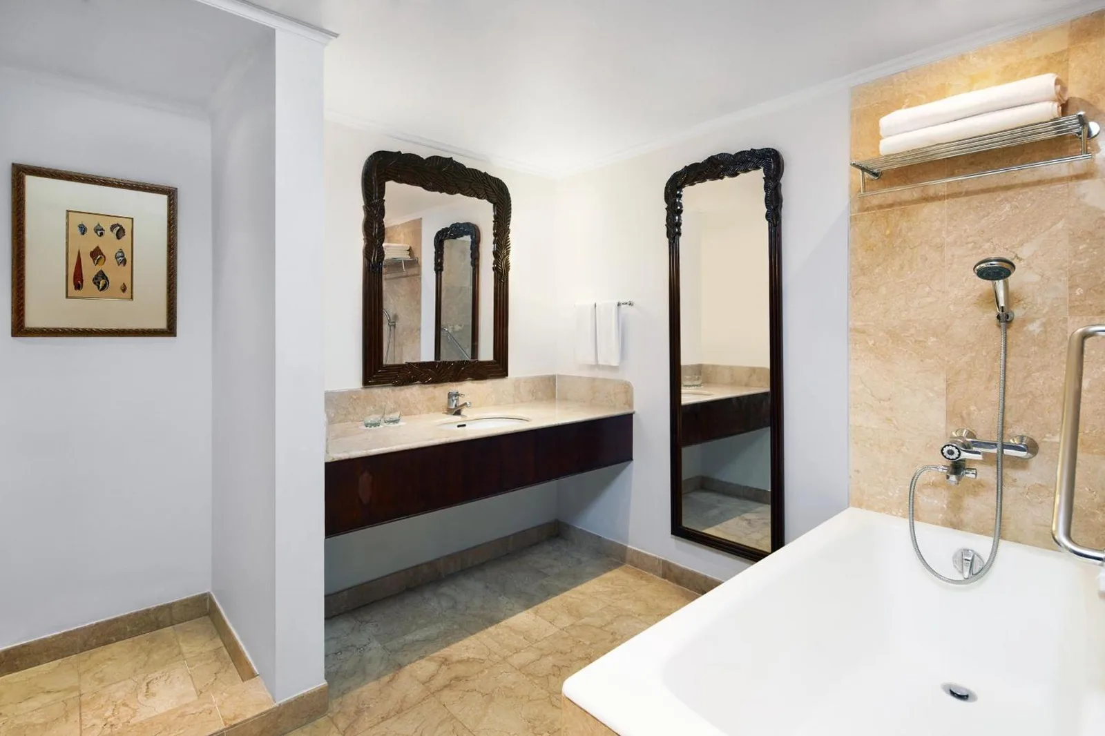 Bathroom vanity at Sheraton Senggigi Beach Resort in Mataram with sink, mirror, and bathtub area.