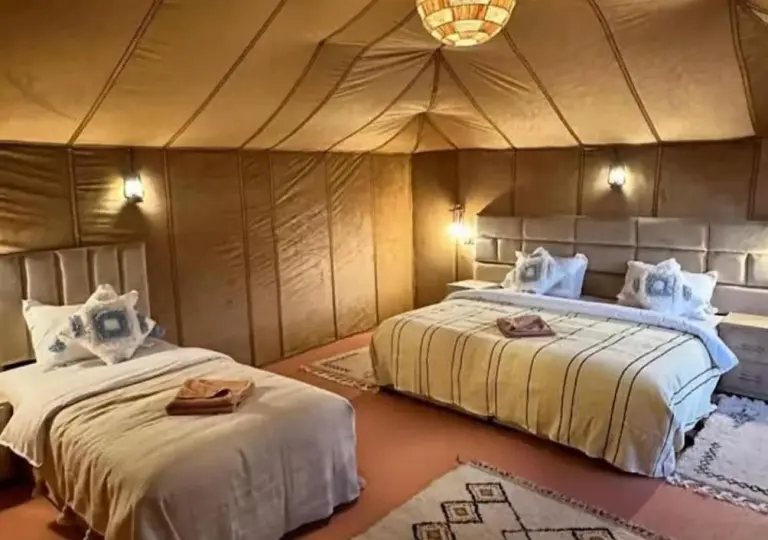 Triple tent room at Shining Luxury Camp in Merzouga with one double bed and one single bed
