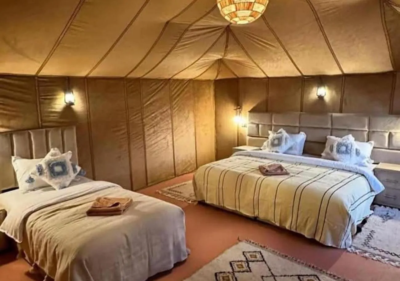 Triple tent room at Shining Luxury Camp in Merzouga with one double bed and one single bed