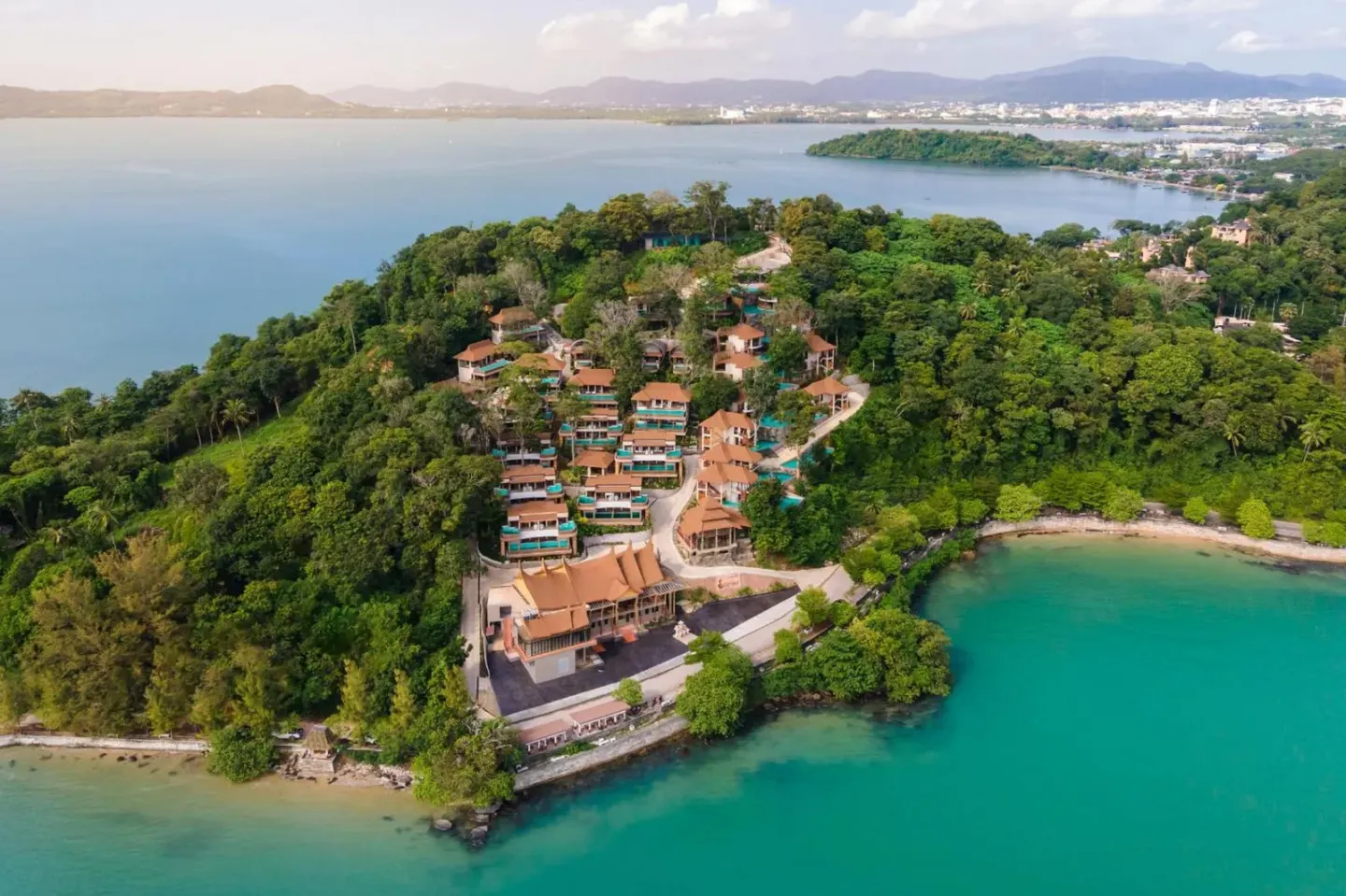 Aerial view of SINAE Phuket Luxury Hotel showcasing lush surroundings and coastal scenery.
