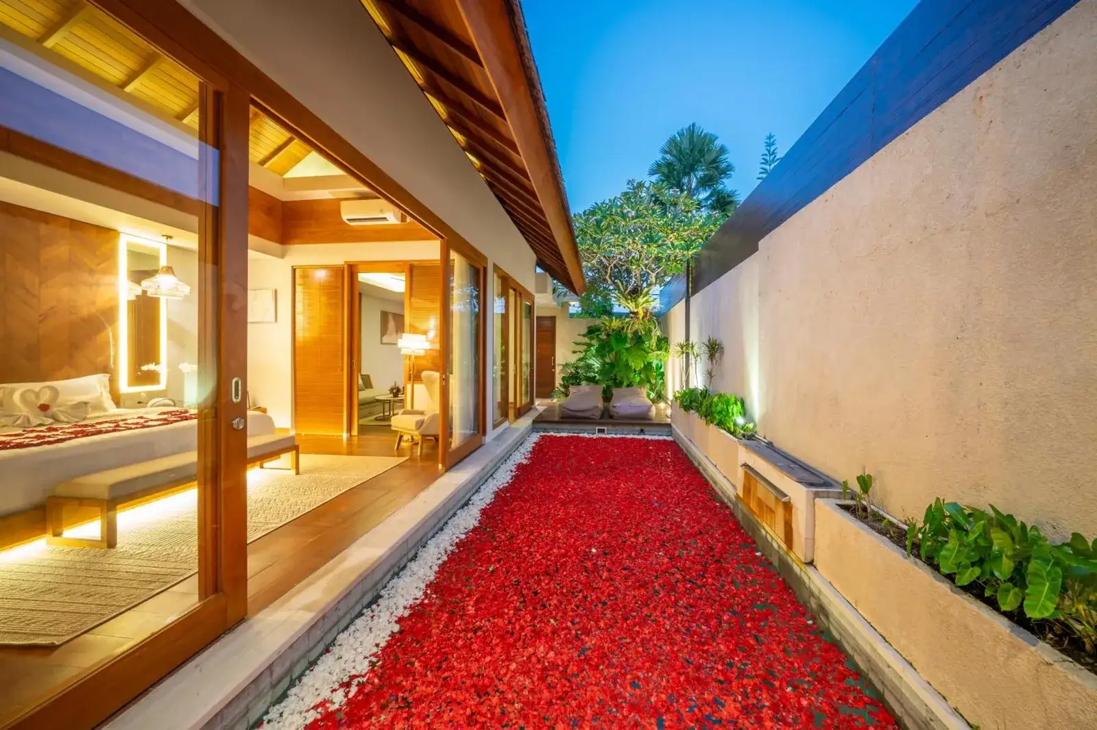 Sithala Villa Seminyak private garden with flower decoration at dusk