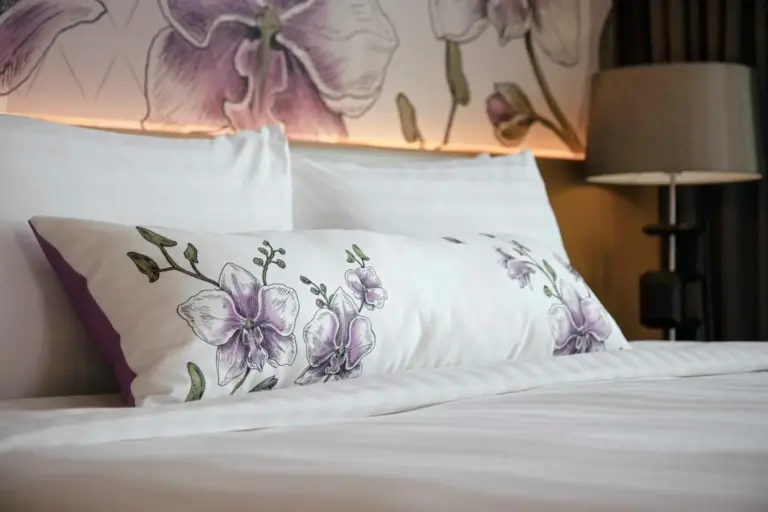 Luxury bedding with floral pillow in Sivatel Bangkok Hotel