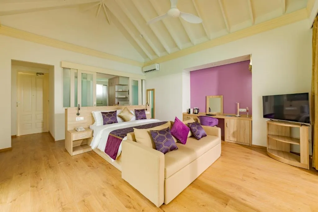 Interior view of a stylish bedroom suite at Siyam World Maldives