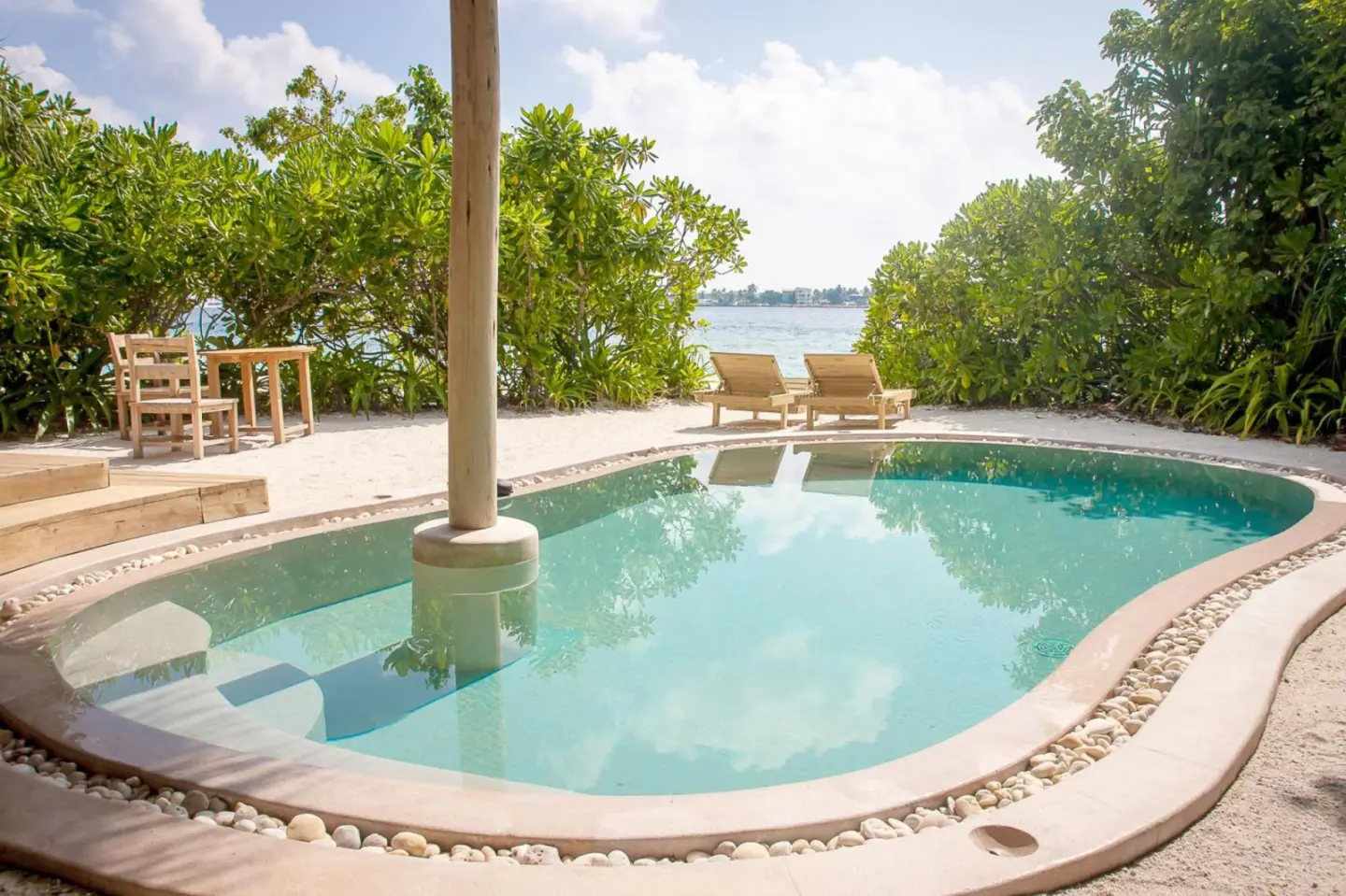 Private pool at Soneva Fushi villa with a view of the ocean.