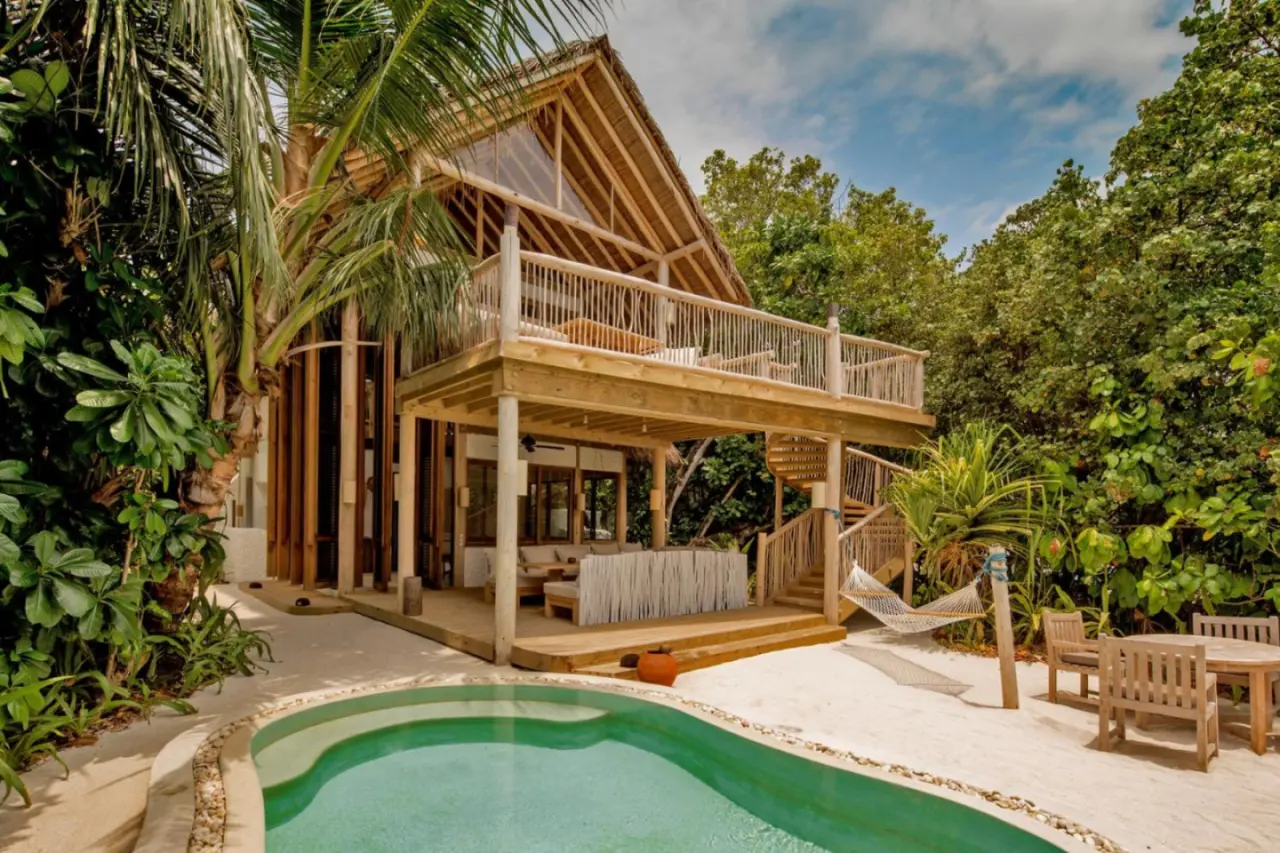 Exterior view of a villa at Soneva Fushi surrounded by lush greenery.
