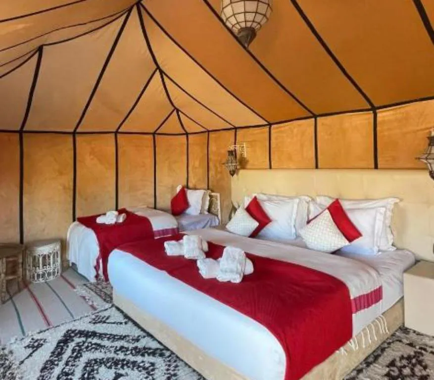 Comfortable bed arrangement in a tent at Stellar Luxury Camp, Merzouga