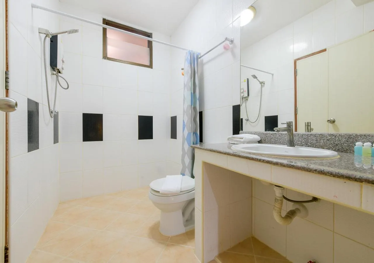 Sun & Beach Pattaya bathroom with toilet, shower, and sink counter