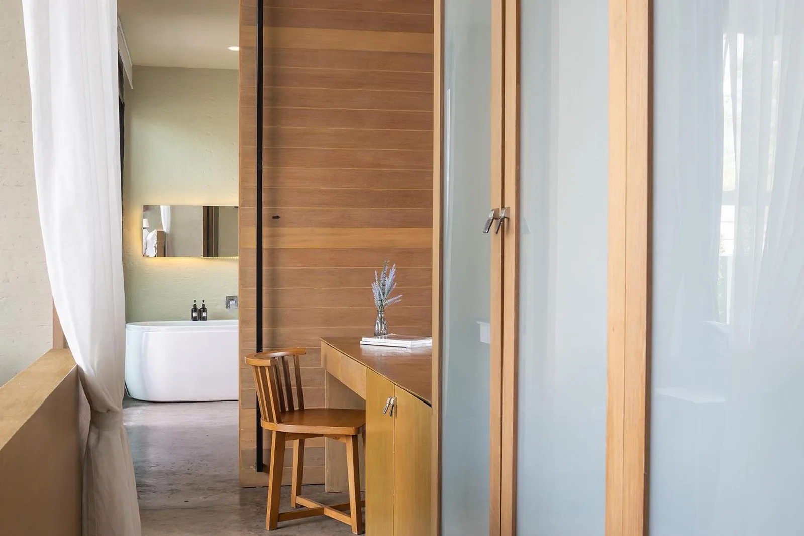 Desk area in Sunday Sea Two Pool Villa Pattaya with wooden furniture and bathroom view