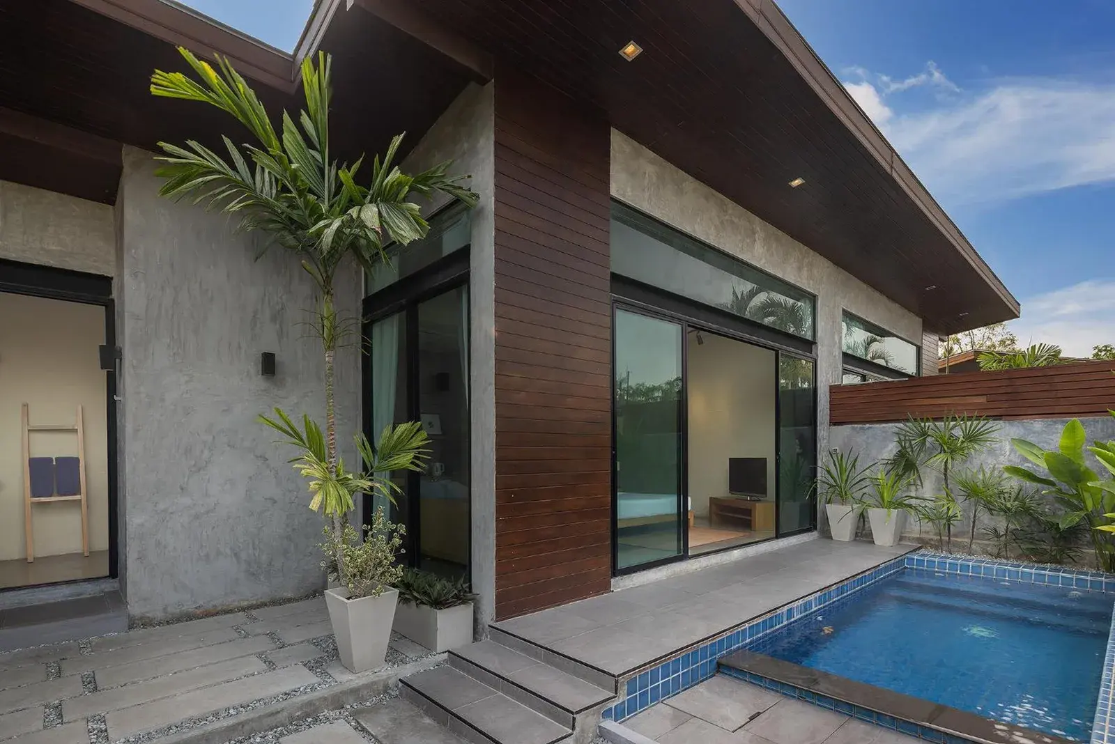 Private pool terrace at Sunday Sea Two Pool Villa Pattaya with modern villa exterior and outdoor seating
