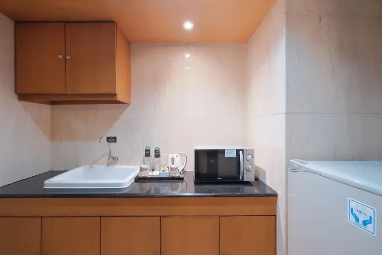 Compact kitchenette in Sunlake Waterfront Resort & Convention Jakarta with sink, microwave, and mini fridge