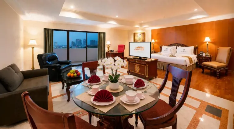 Elegant suite at Sunlake Waterfront Resort & Convention Jakarta with dining area, seating, and king bed