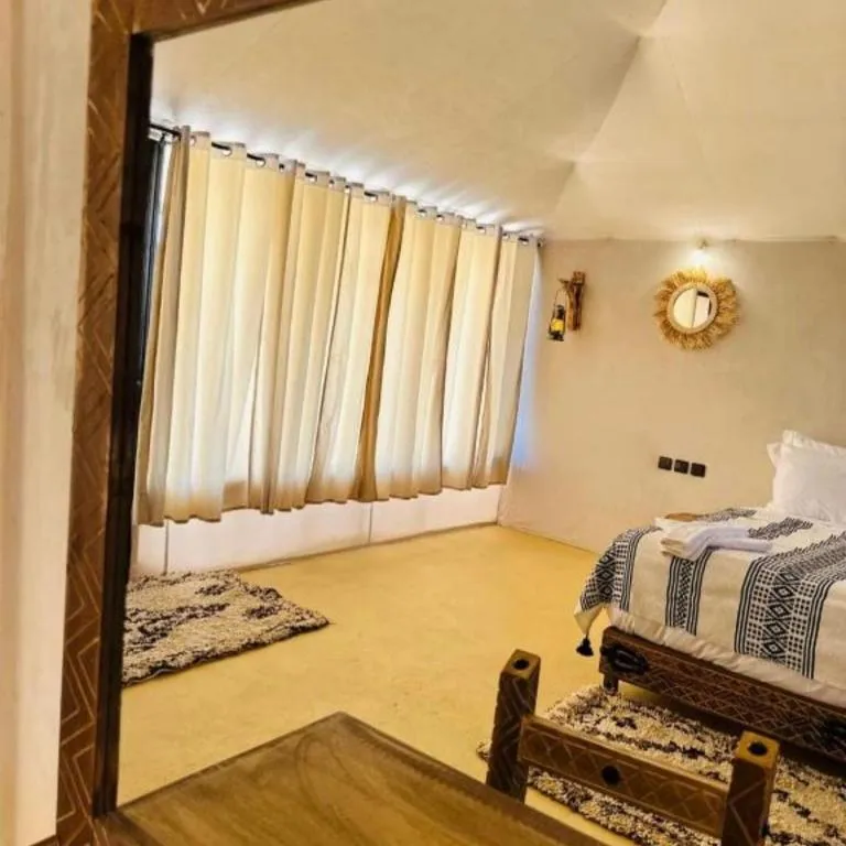 Sunny Luxury Camp tent interior with natural light in Merzouga