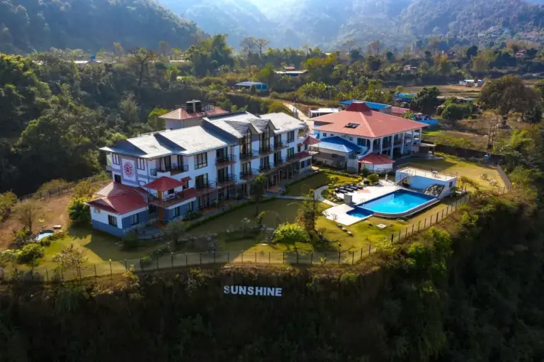 Aerial view of Sunshine Resort Pokhara in Pokhara with landscaped grounds and swimming pool, Nepal hotel exterior for SEO.