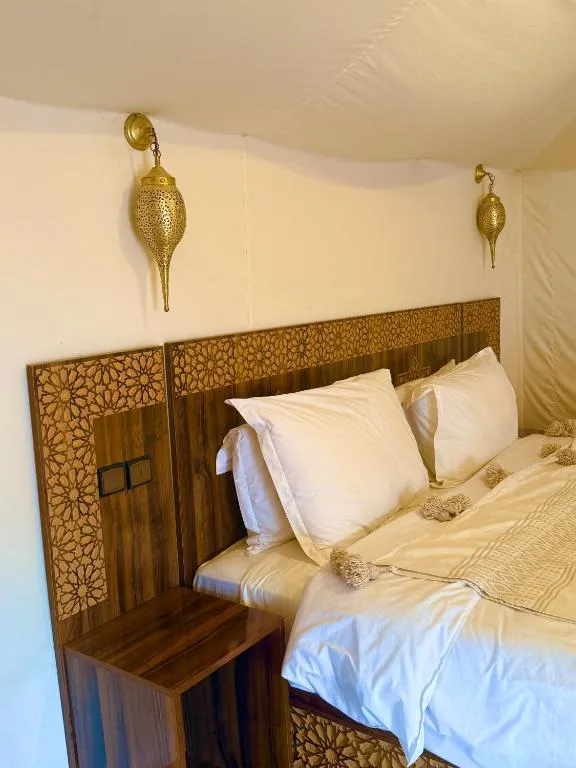 Bed detail in tent at Tamazirt Desert Camp in Merzouga