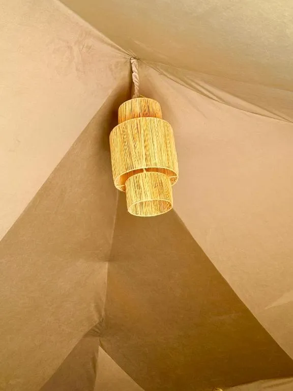 Stylish light fixture in tent at Tamazirt Desert Camp in Merzouga