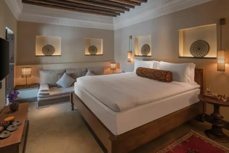The Chedi Al Bait cozy suite with a comfortable bed