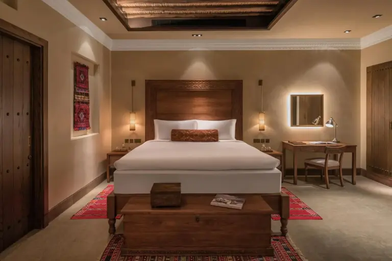 The Chedi Al Bait deluxe room with a king-size bed and decor