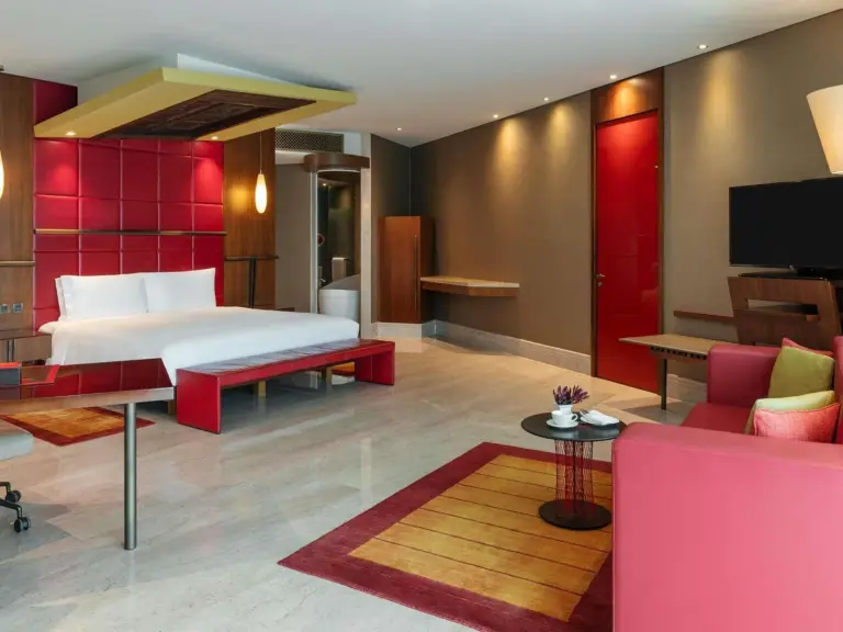 Spacious guest room at The Creekside Hotel, Dubai, an Accor Hotel, with a king bed, seating area, and modern decor
