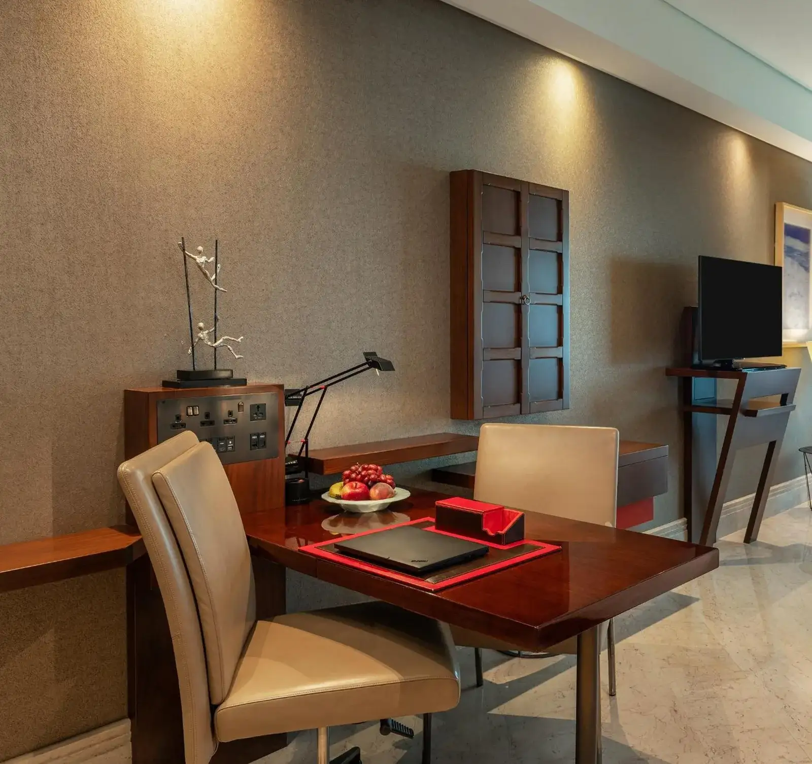 In-room workspace at The Creekside Hotel, Dubai, an Accor Hotel, with desk, chairs, and television