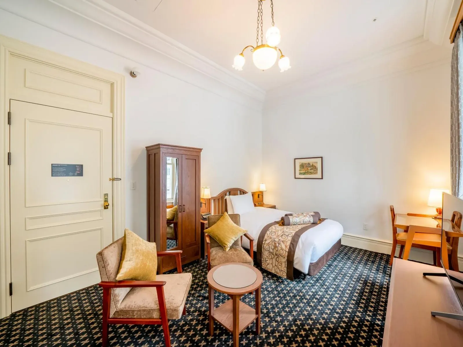 A spacious room at The Fujiya Hotel in Hakone with a comfortable layout and tasteful decor.